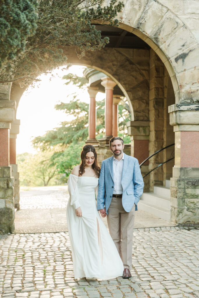 couple standing in front of arch at Maymont Mansion