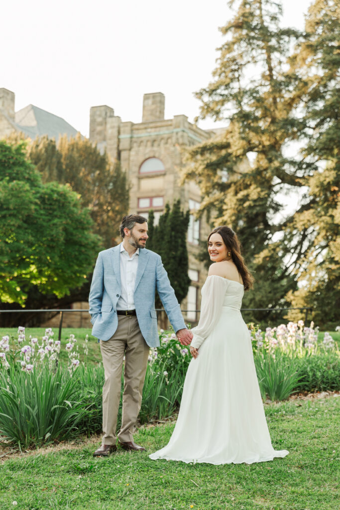 couple standing in front of garden of irises