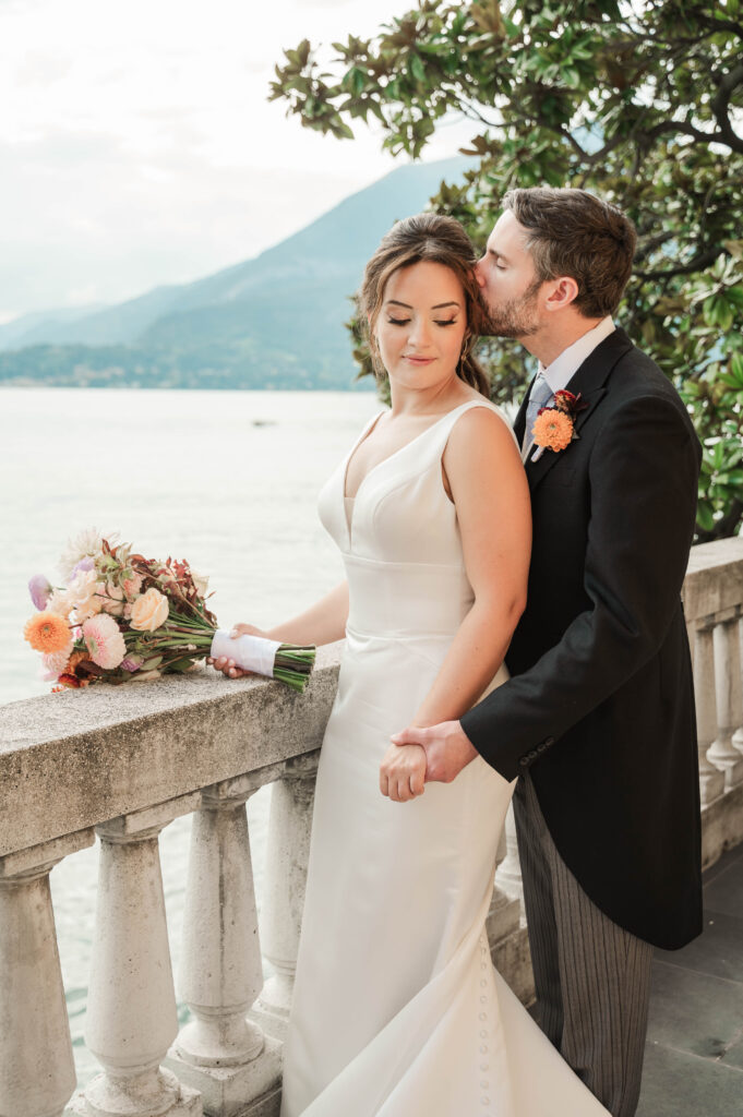 bride and groom portraits on a balcony at Hotel Villa Cipressi