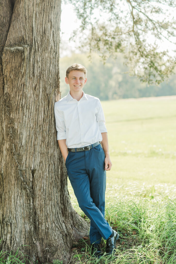 graduate leaning against tree Charlottesville, Virginia