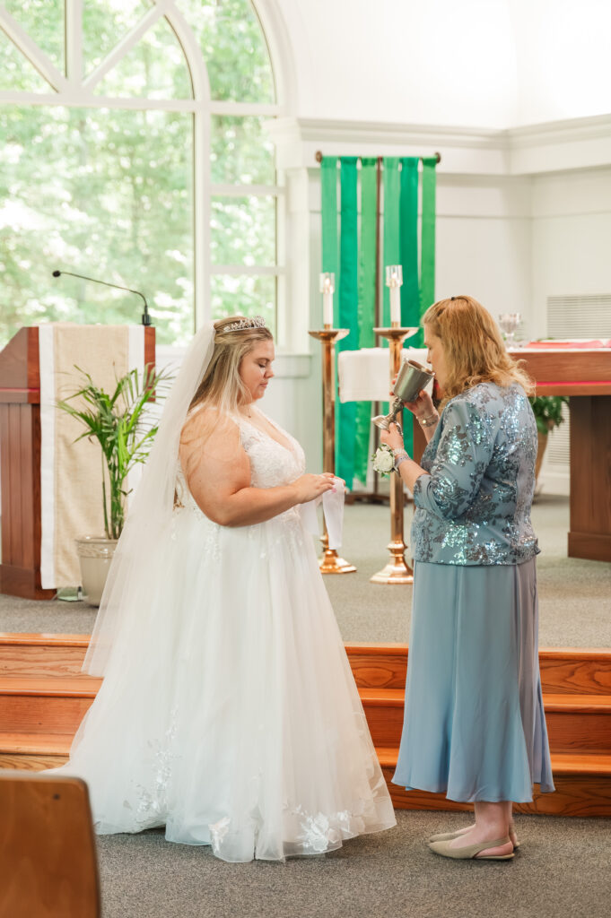 bride giving mom communion at wedding ceremony