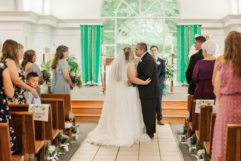 father giving away bride at ceremony