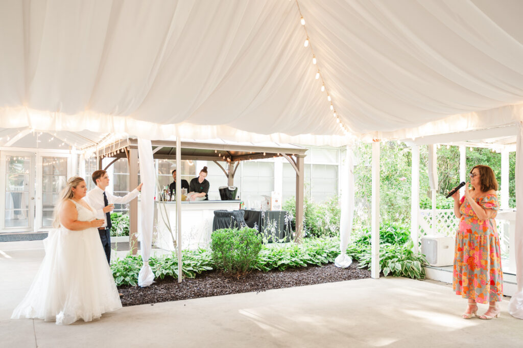 winner of anniversary dance giving advice to bride and groom