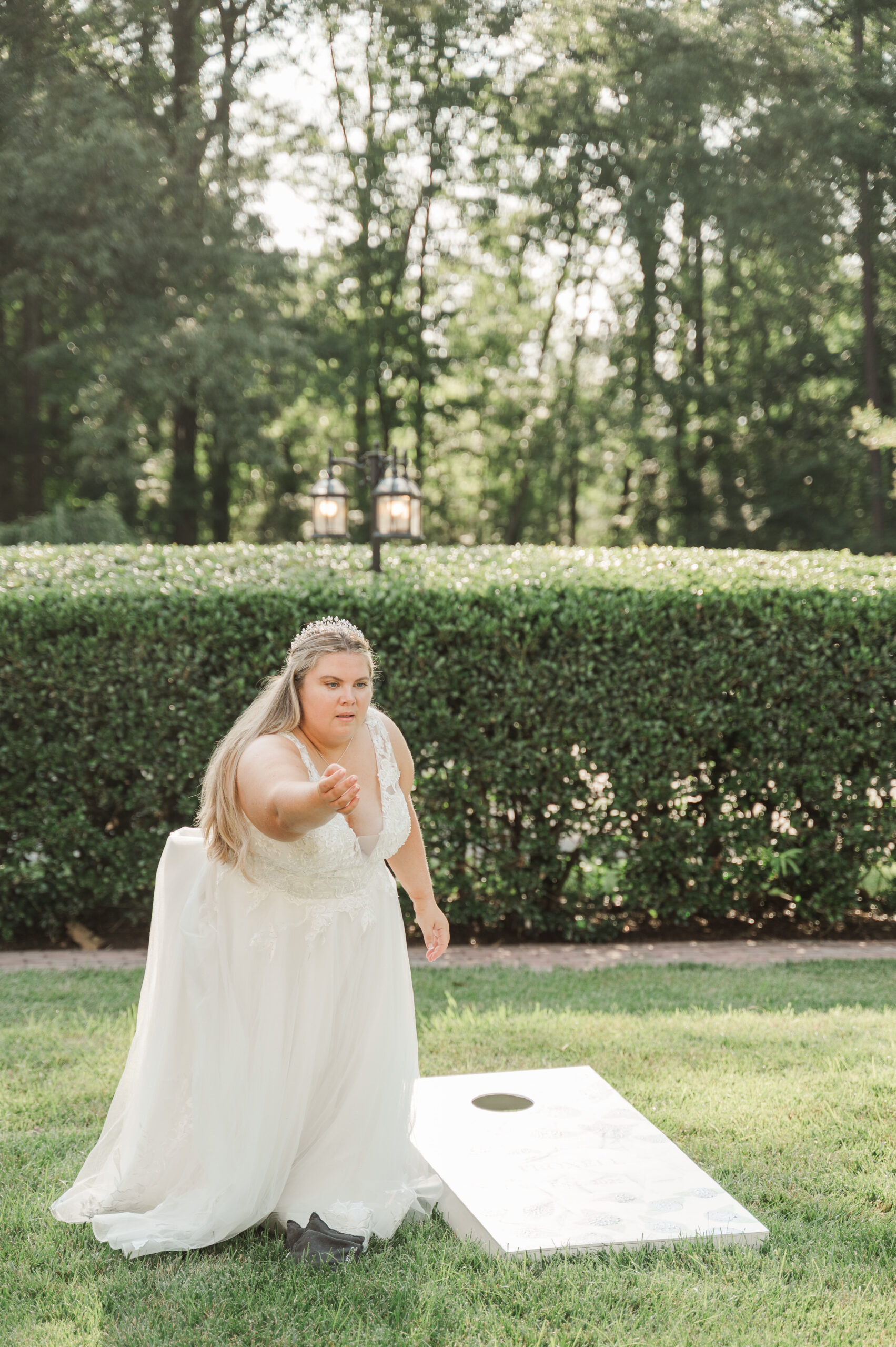 bride playing corn hole