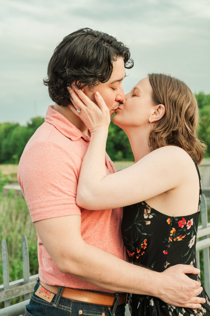 Candid moment of the couple kissing at their Virginia nature engagement session.