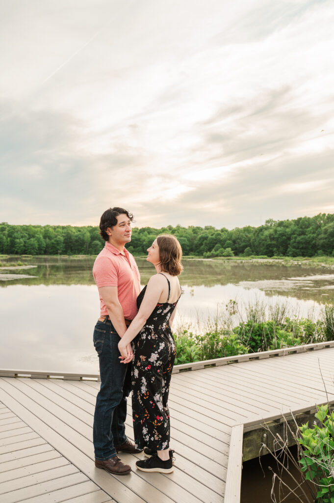 Chelsea and Alex standing on the boardwalk during their Huntley Meadows engagement session in Northern Virginia.