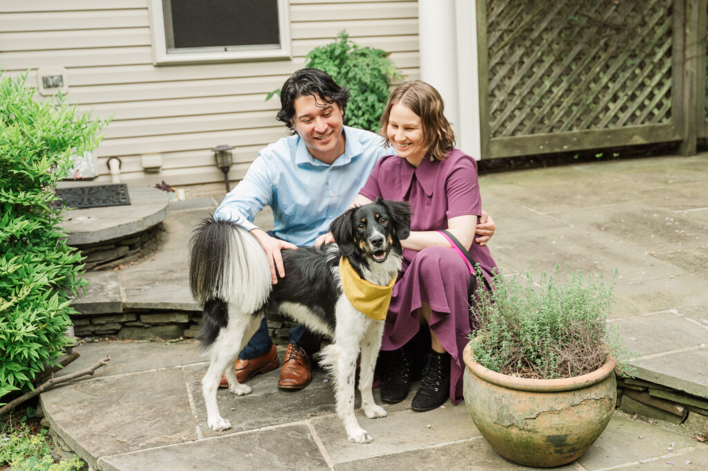 Chelsea and Alex posing with their dog Sidney at Alex’s mom’s house before their Huntley Meadows engagement photos.