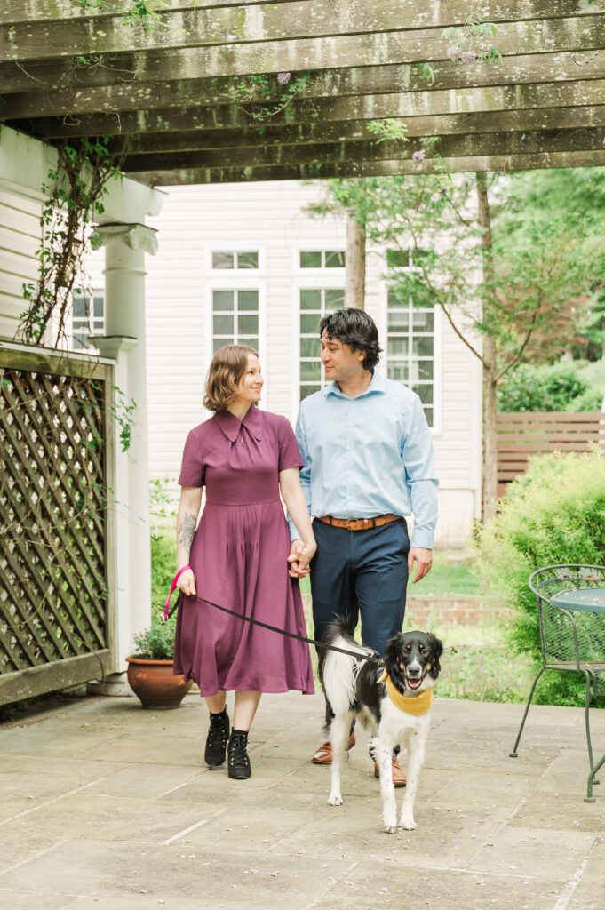 Chelsea and Alex walking with their dog Sidney at Alex’s mom’s house before their Huntley Meadows engagement photos.