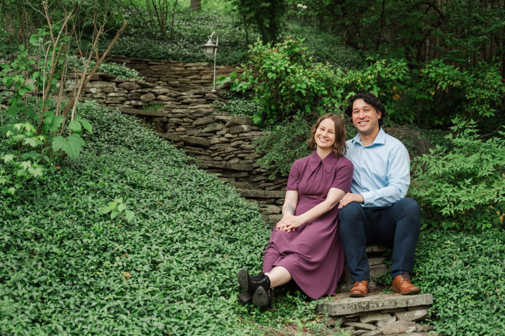 couple sitting on rock path at Alex's mom's house in Northern Virginia