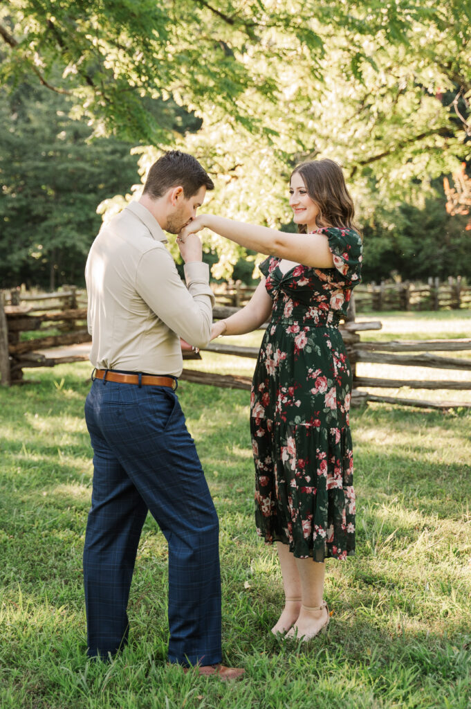groom to be kissing his future bride's hand