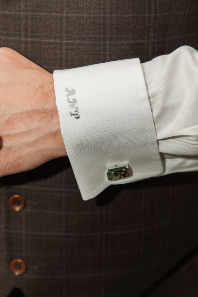 groom's cufflinks and sleeve with embroidered initials