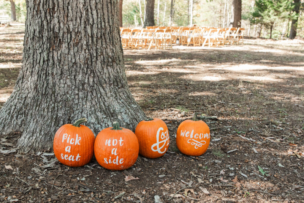 Ceremony site with pumpkins directing guests