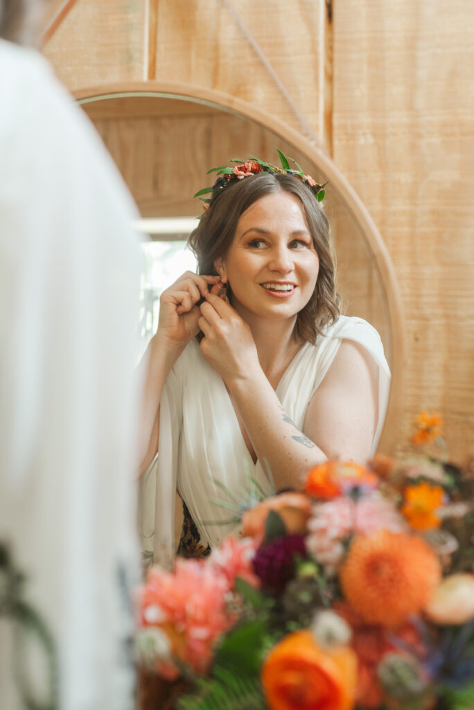 bride putting in earrings