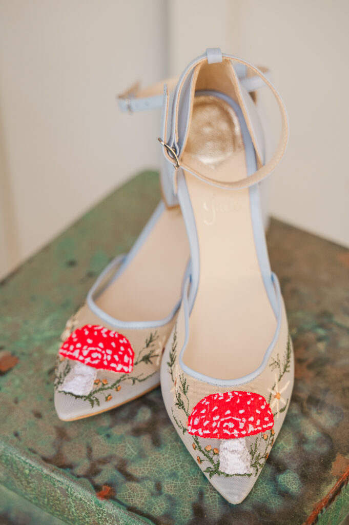 bride's wedding shoes with mushrooms on the shoe