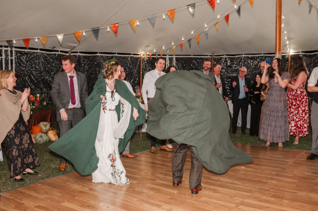 bride and groom with capes during reception