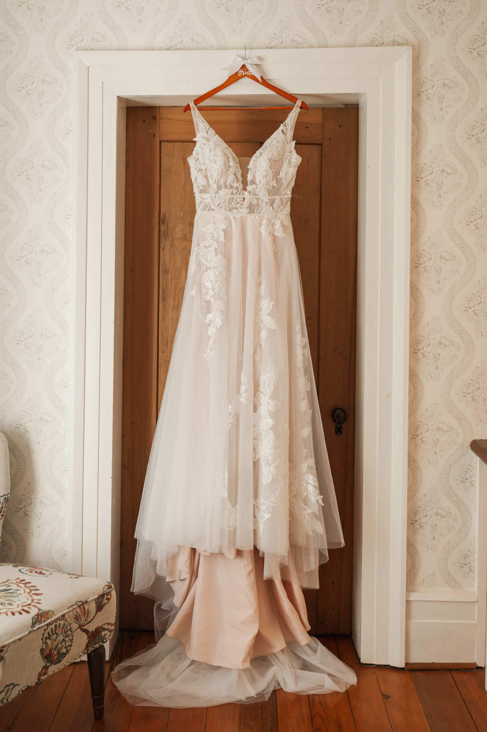 Wedding dress hanging on door at Valley Mills Farm