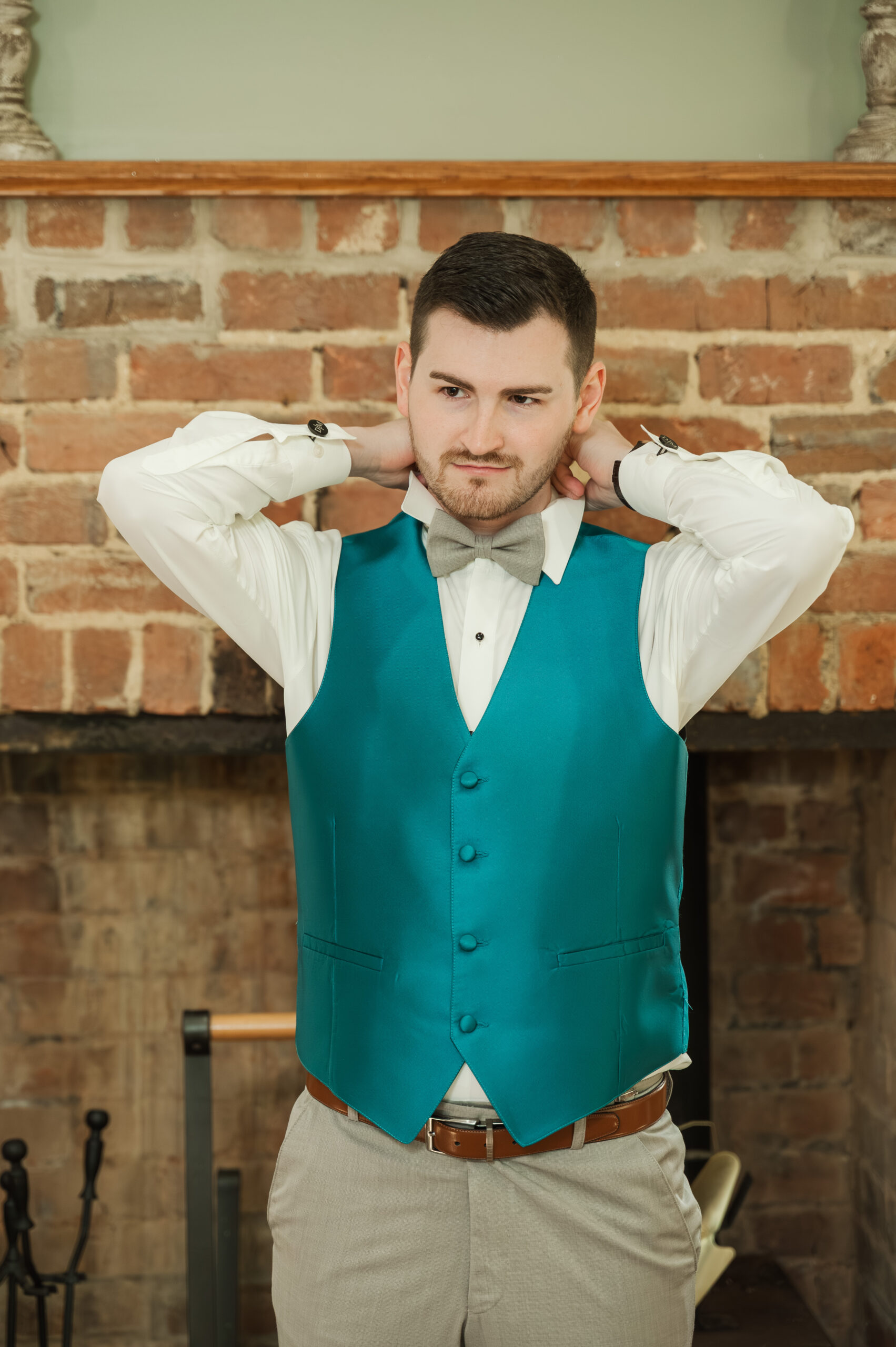 Groom Devin adjusting his collar before the ceremony.