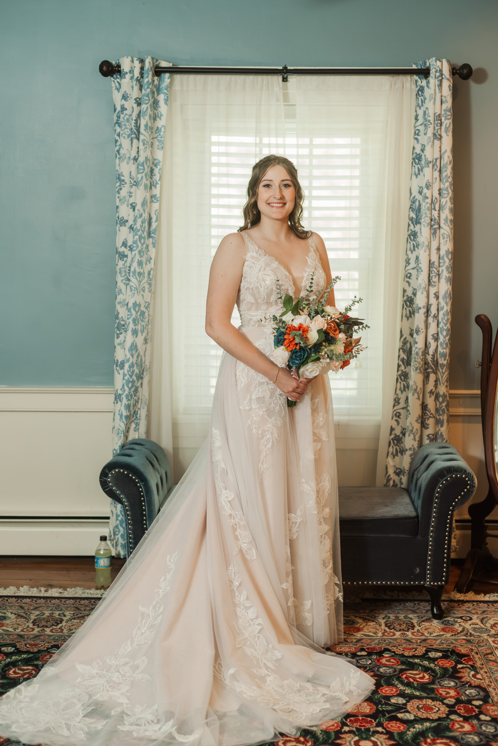 Bride McKenzi smiling while getting ready before her wedding at Valley Mills Farm.