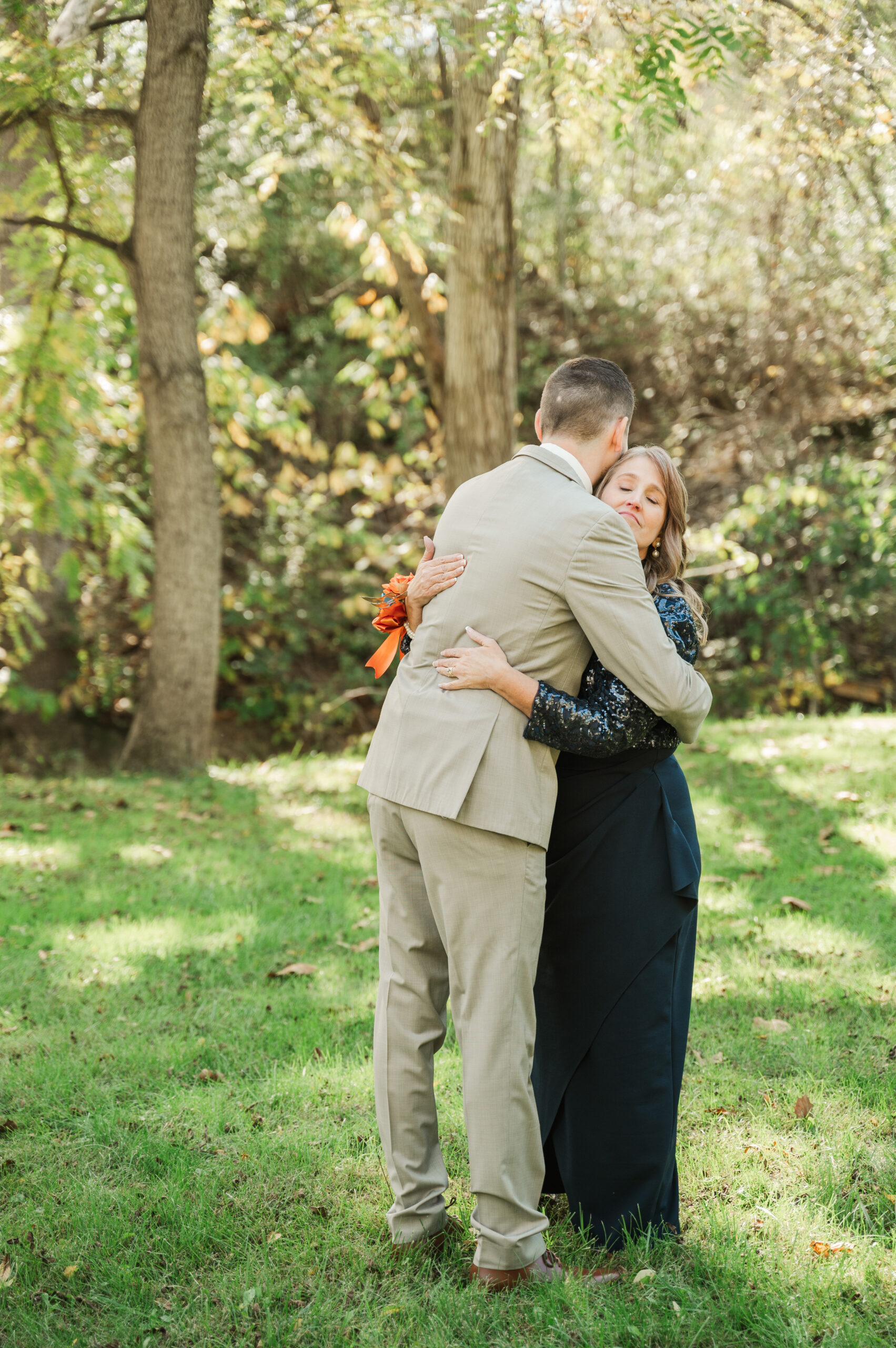 Groom hugging Mom after first look