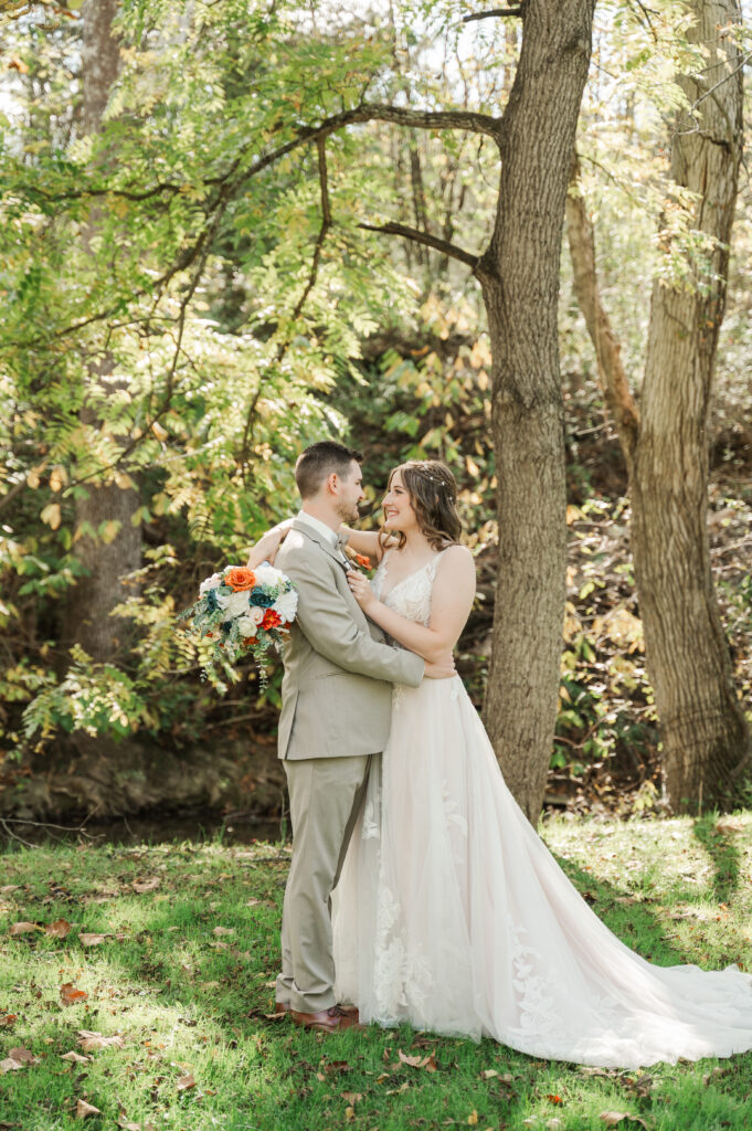 Romantic bride and groom portraits by the river at Valley Mills Farm.