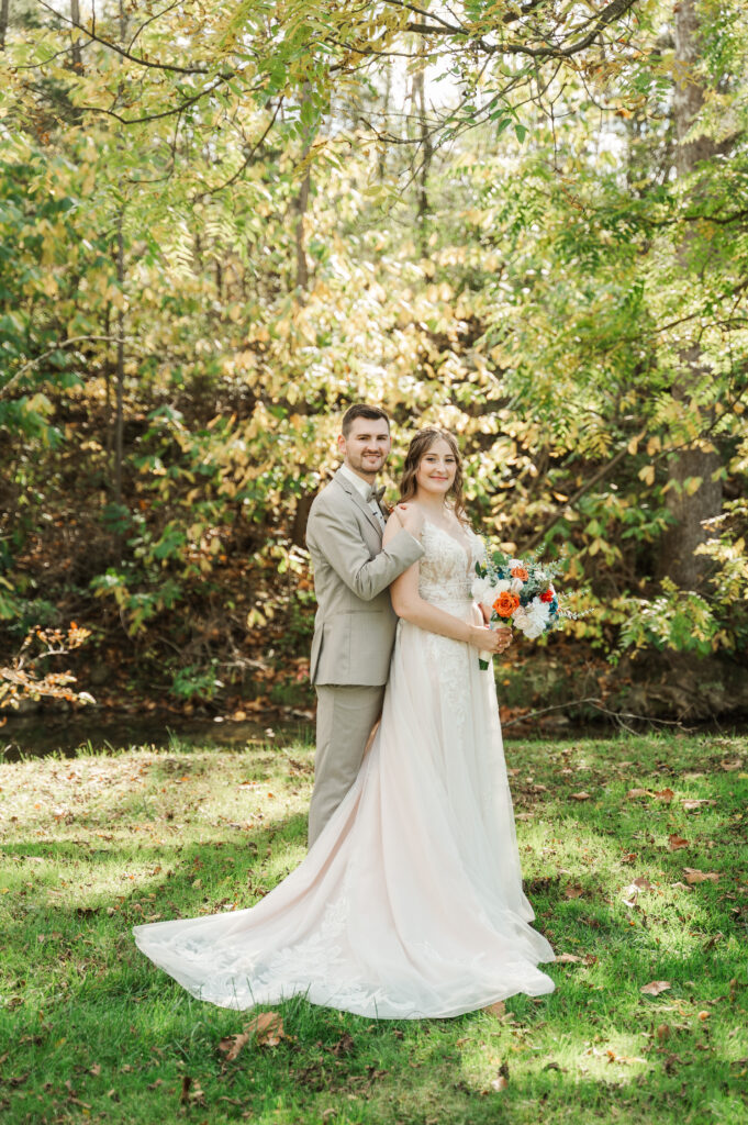 Romantic bride and groom portraits by the river at Valley Mills Farm.