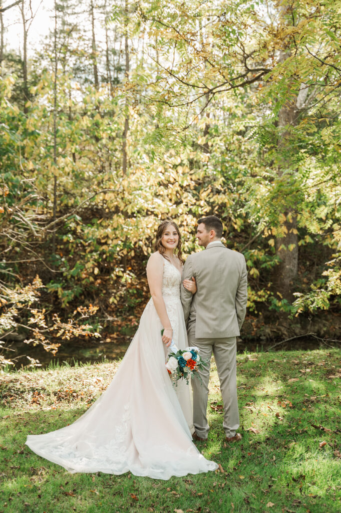 Romantic bride and groom portraits by the river at Valley Mills Farm.