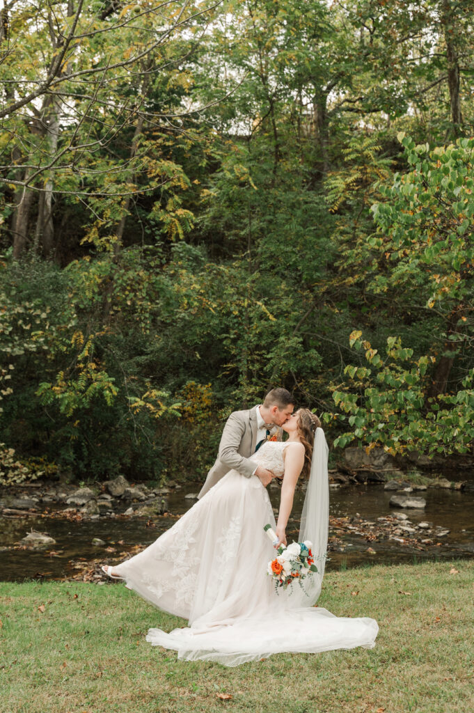 Romantic bride and groom portraits by the river at Valley Mills Farm.