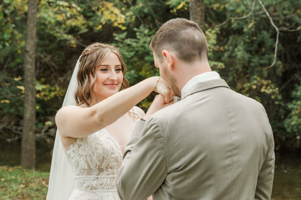 groom kissing bride's hands