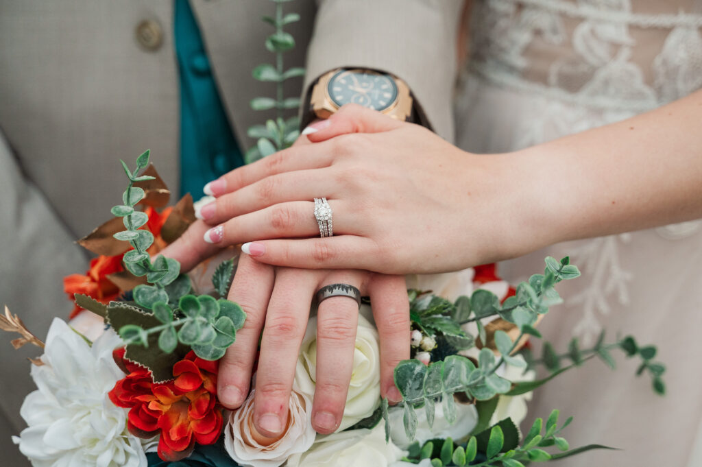 close of of bride and groom wedding rings on hands