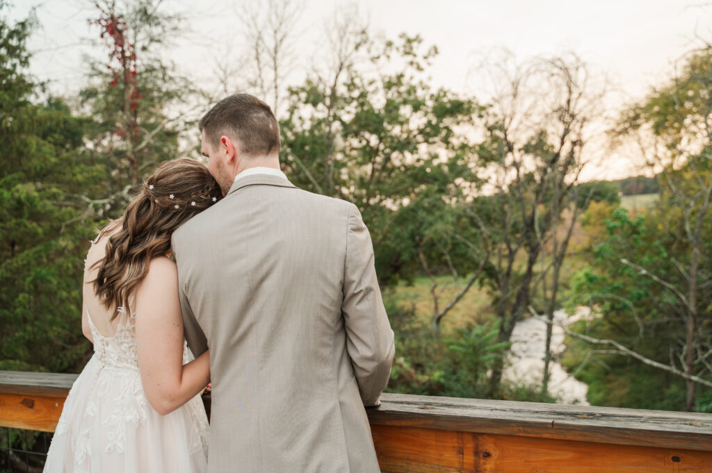 bride and groom looking at views of river
