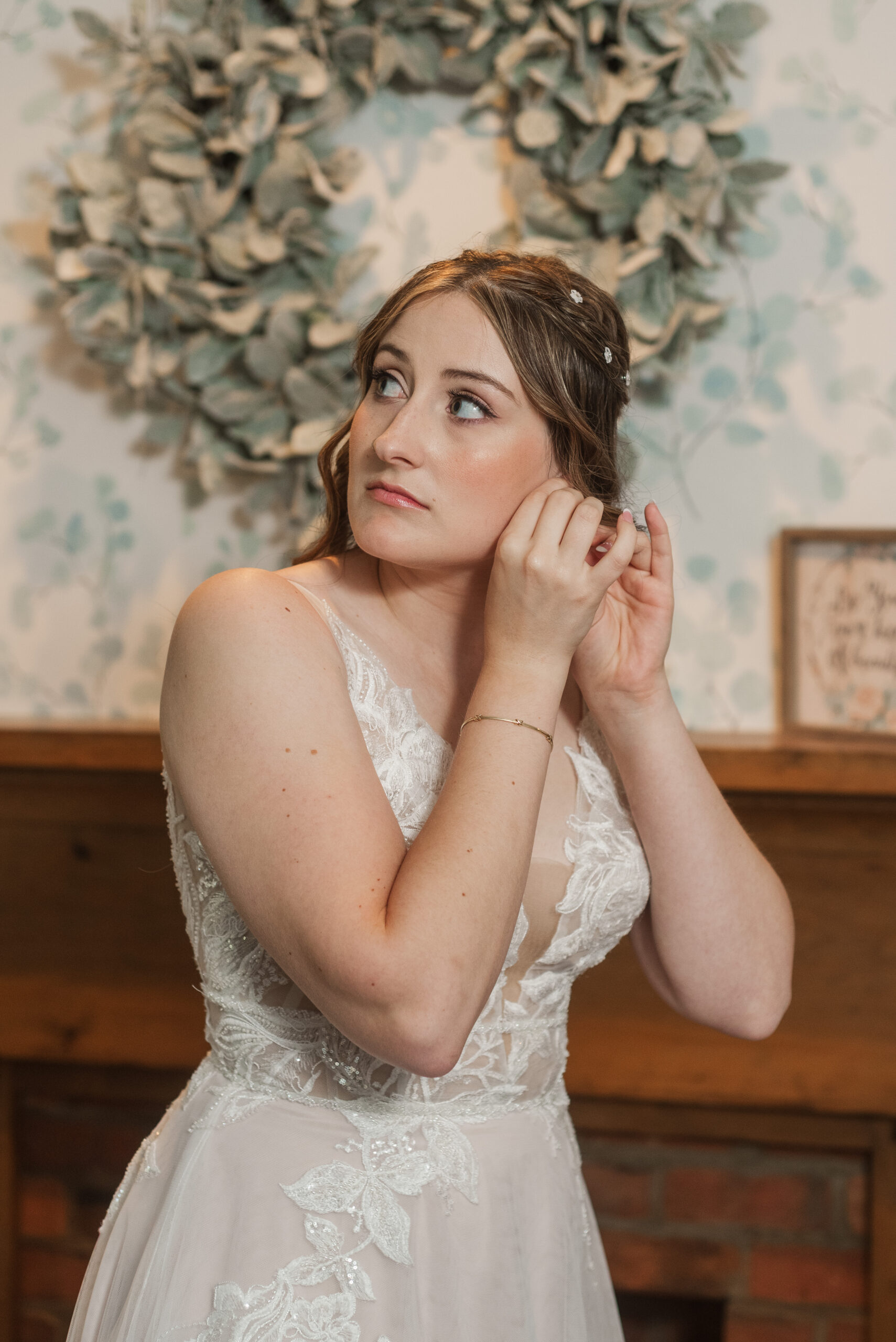 bride putting on earrings