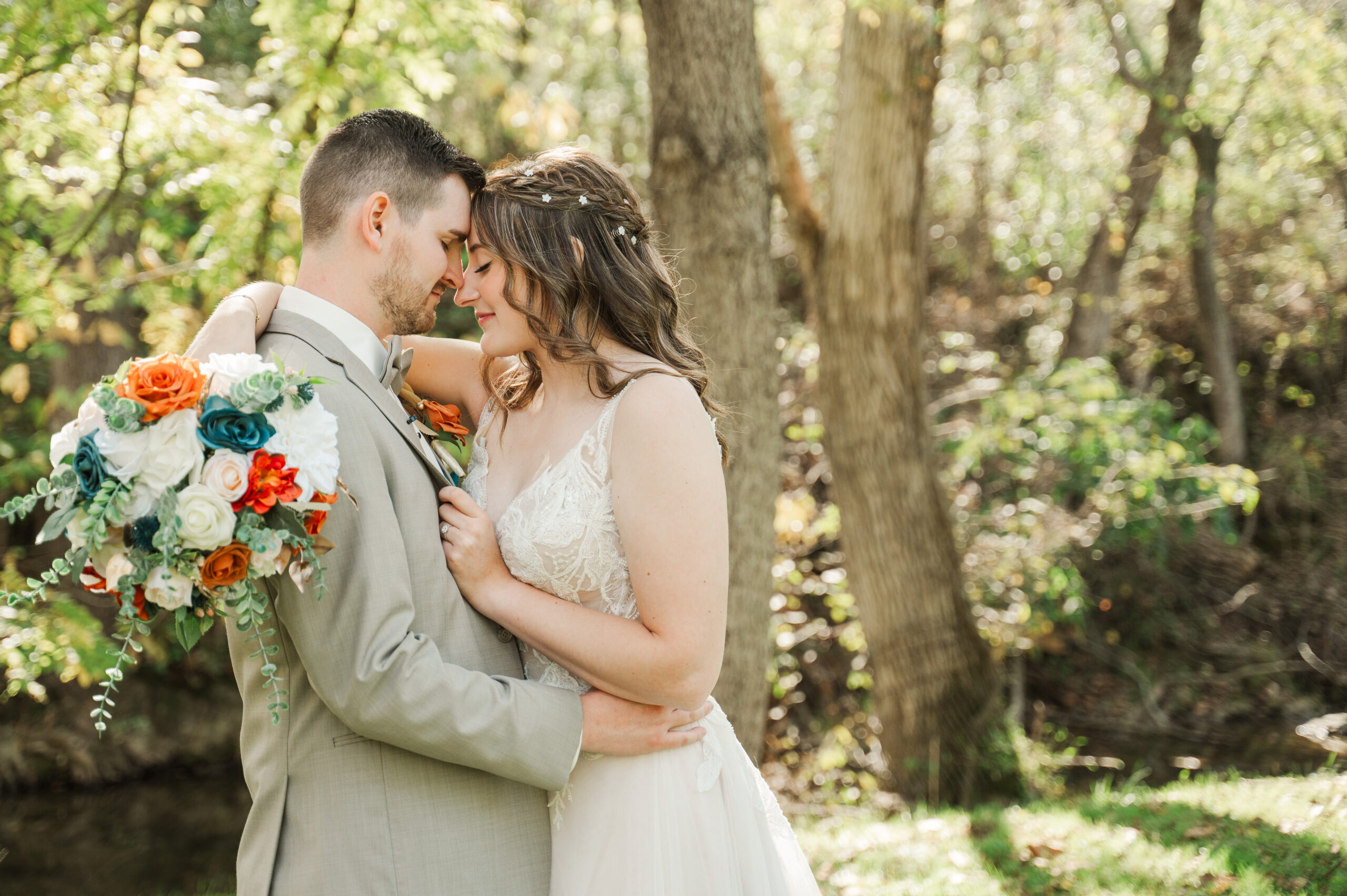 Romantic bride and groom portraits by the river