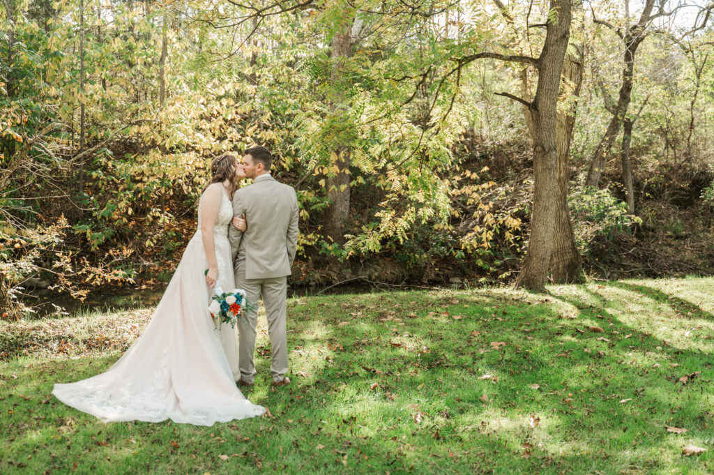 Romantic bride and groom portraits by the river at Valley Mills Farm.