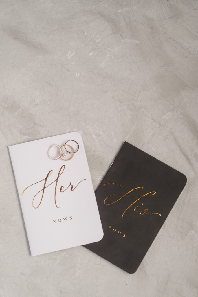 vow books with wedding rings