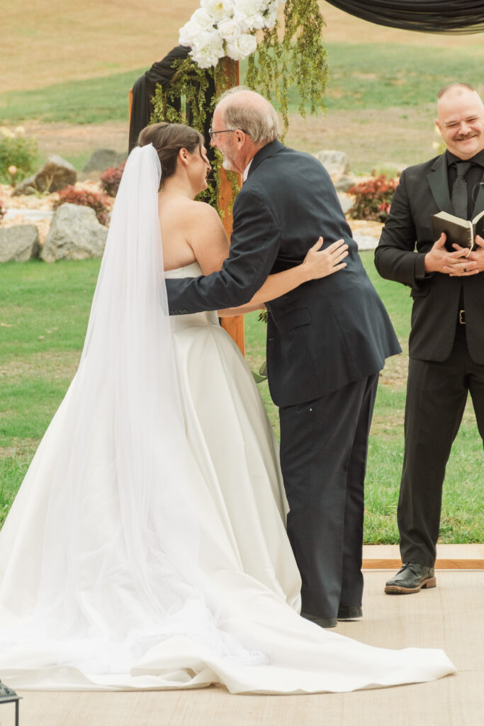 father giving bride away