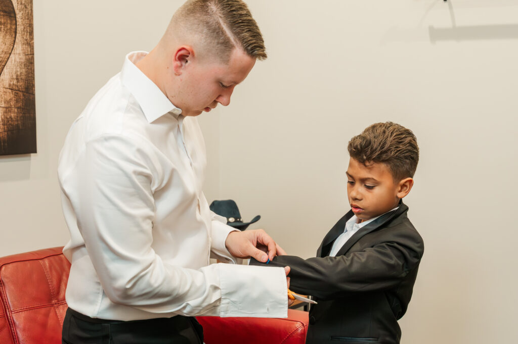 groom helping son get ready