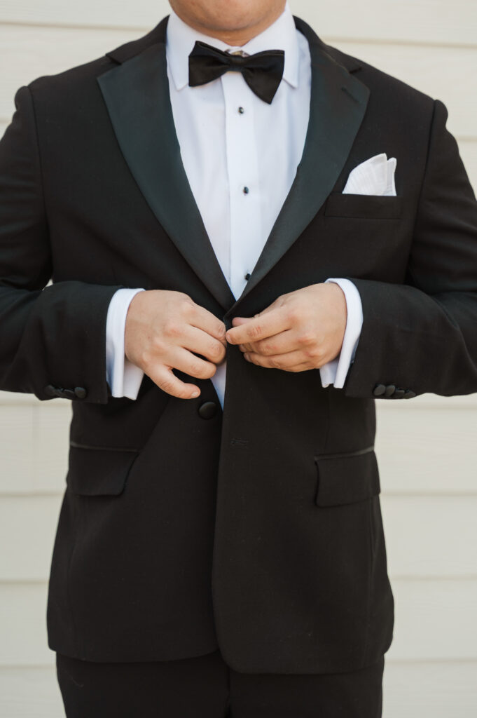 groom buttoning jacket