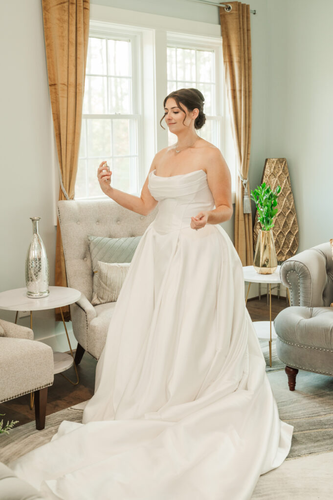 bride putting on perfume