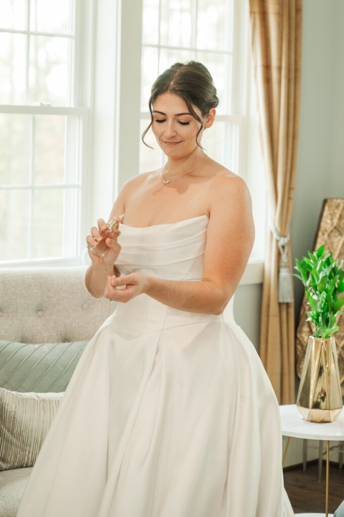 bride putting on perfume