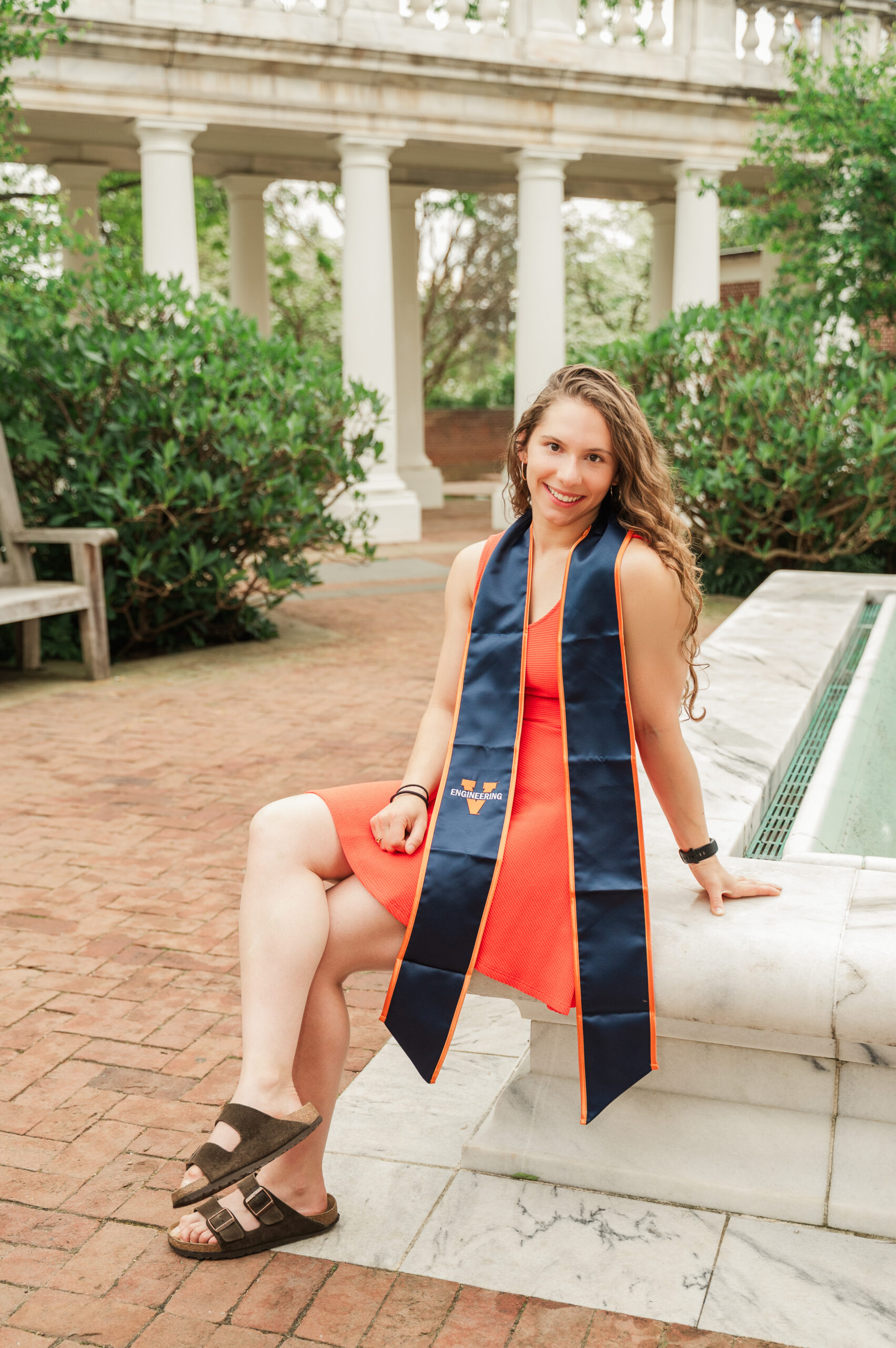 Emily sitting on fountain in East Courtyard at UVA Rotunda