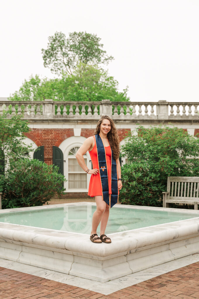 Emily standing on the fountain in the East Courtyard