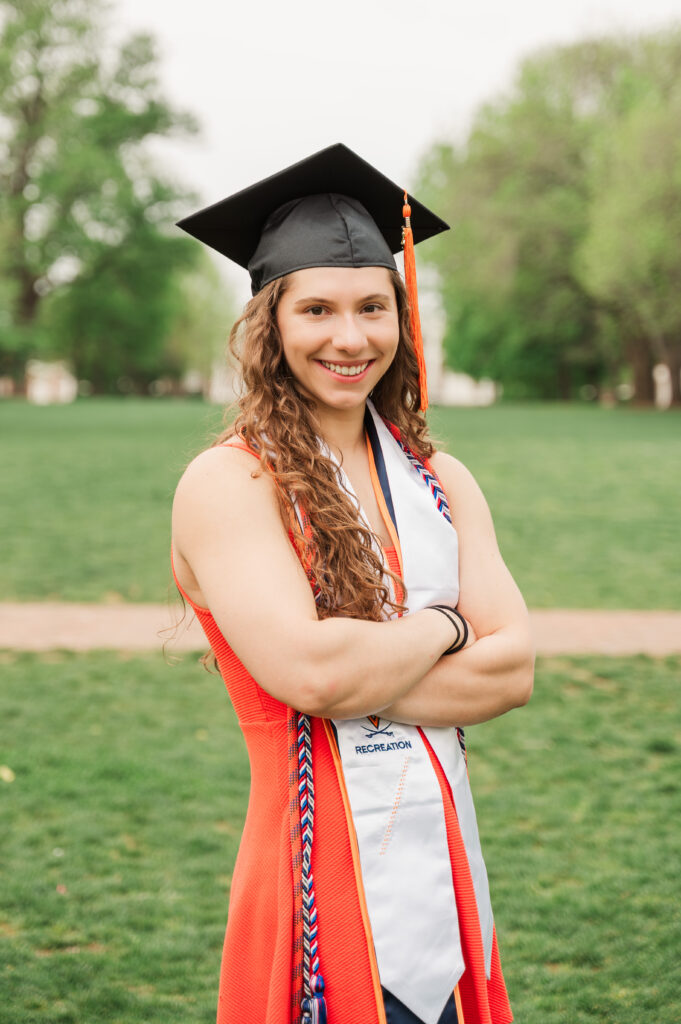 Emily standing on Lawn with arm crossed wearing cap and stoles