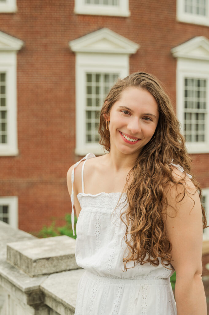 Emily sitting with Rotunda in the background