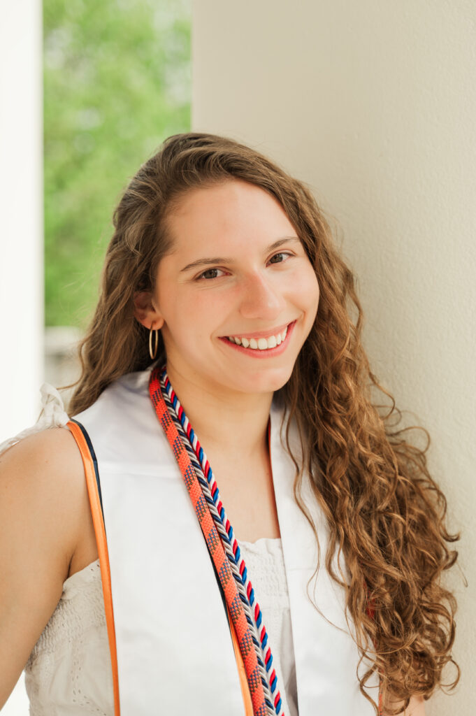 close up of Emily leaning on white column on Rotunda Portico