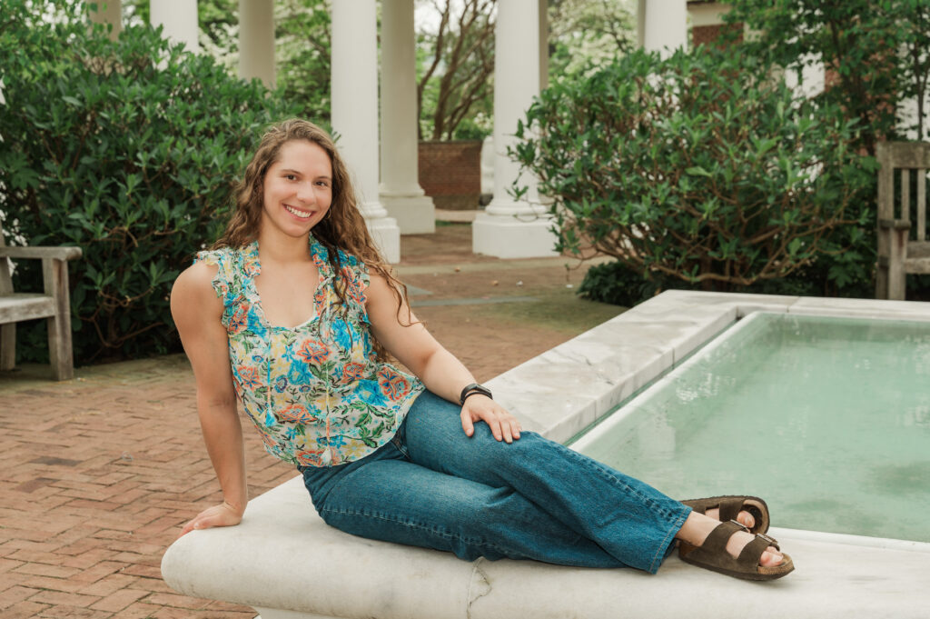 Emily sitting on fountain in East Courtyard