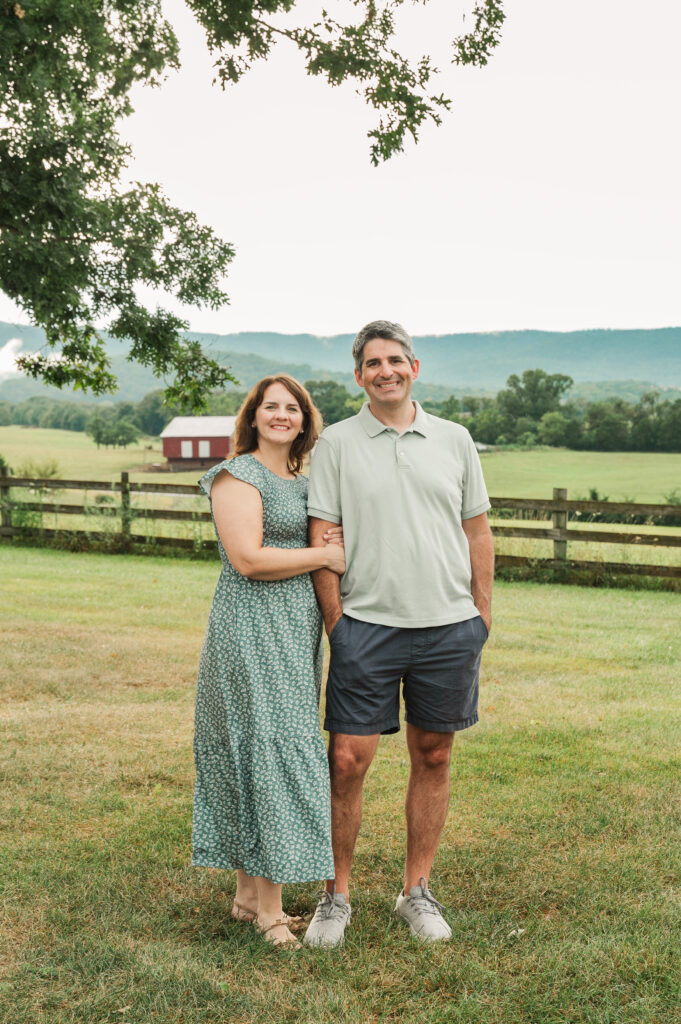 Couple photo with fence and Blue Ridge Mountains in the background