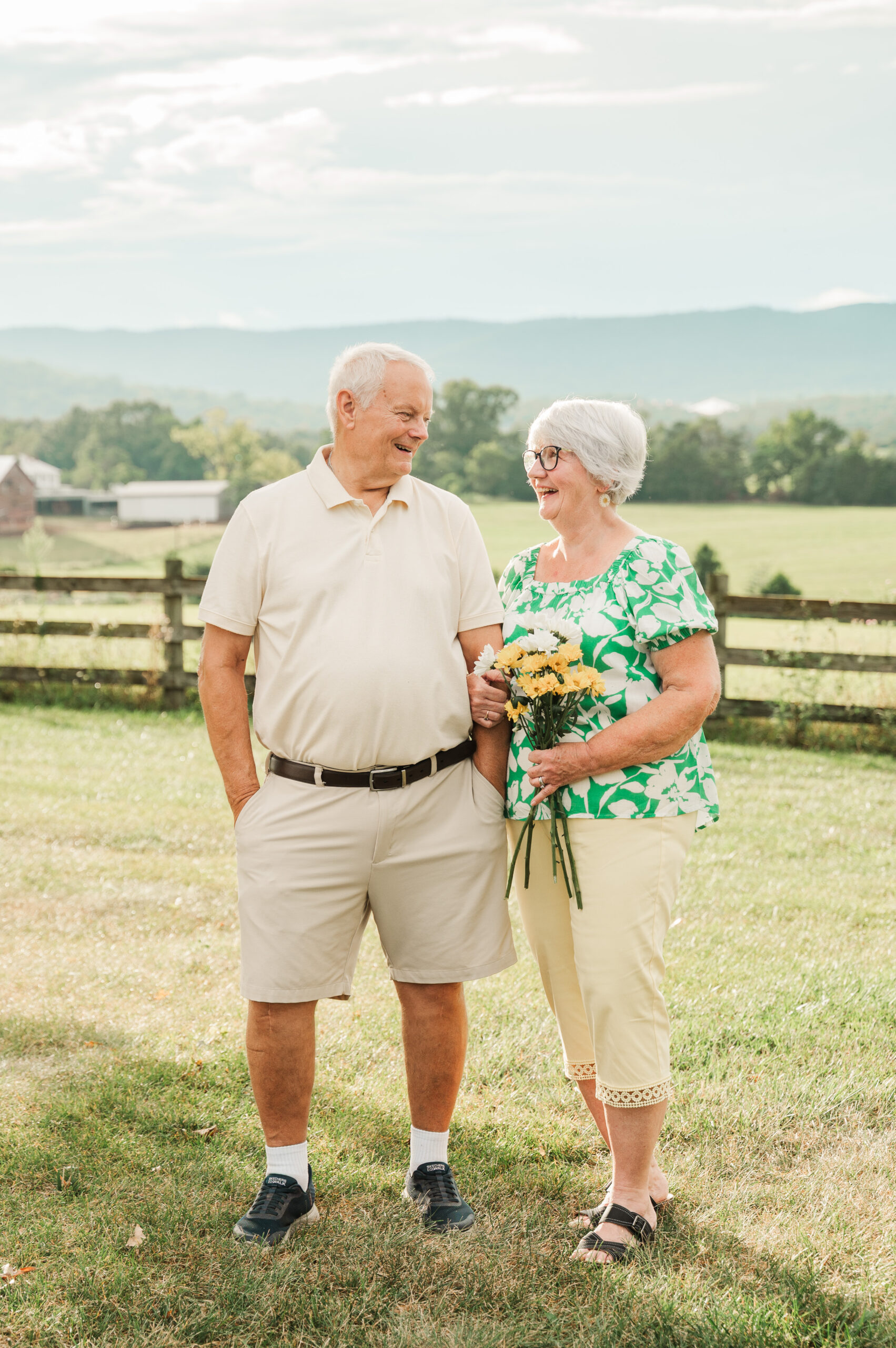 Grandparents holding daisies to celebrate their 50th anniversary at a private estate in Elkton, VA