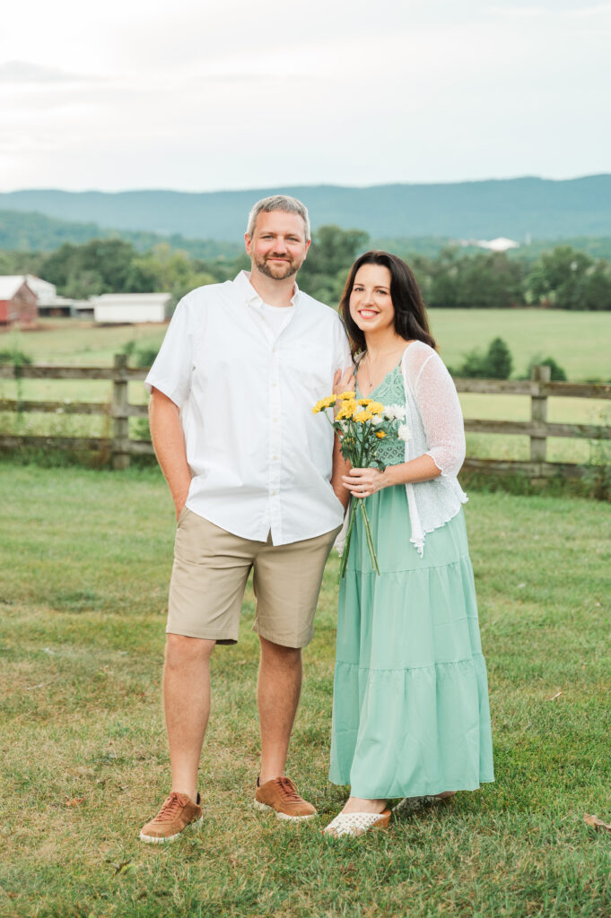 mom and dad portrait with daisies and mountain views