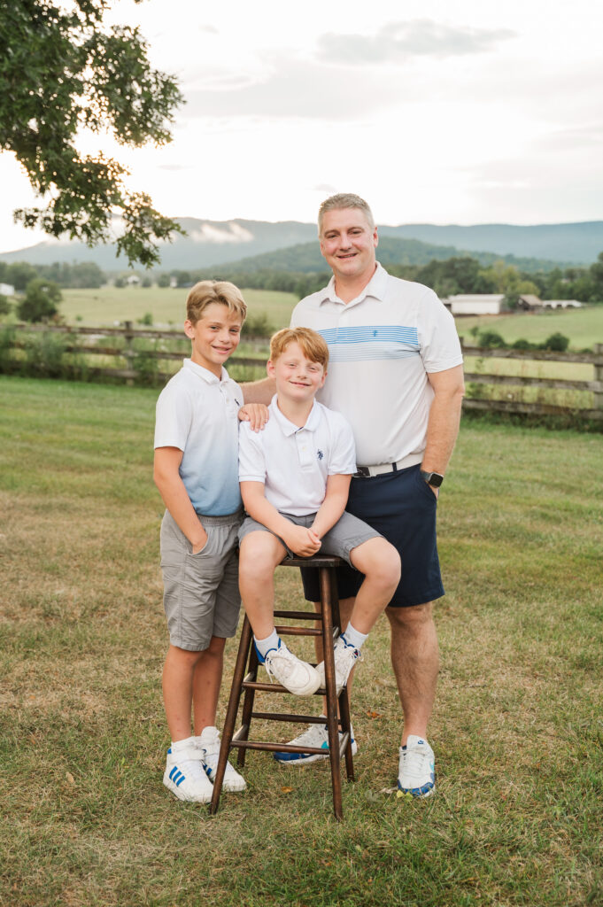 father with sons and sweeping mountain views
