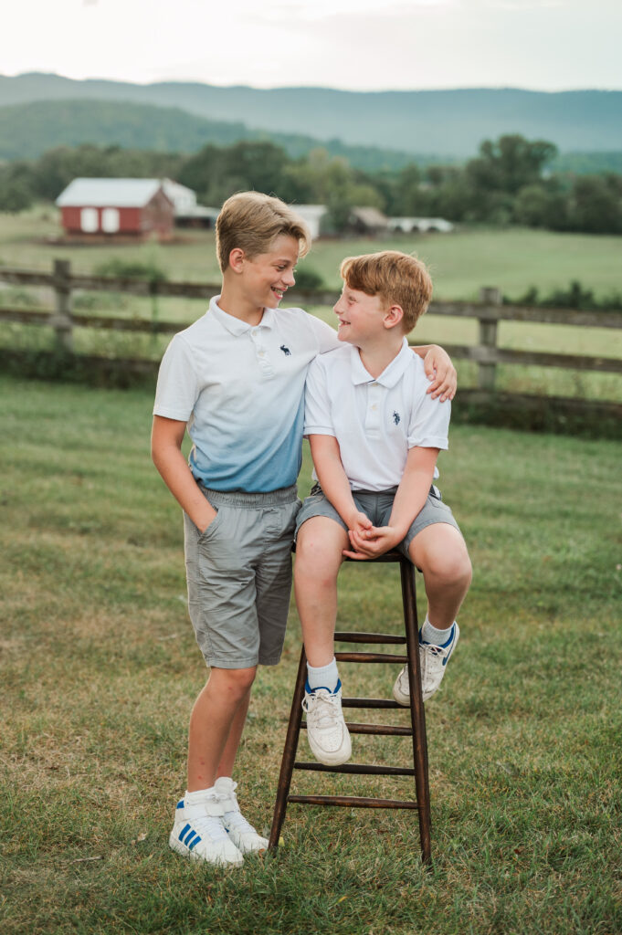 brothers looking at each other laughing during extended family vacation photo session